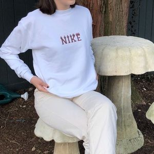 White and brown Nike flame crewneck